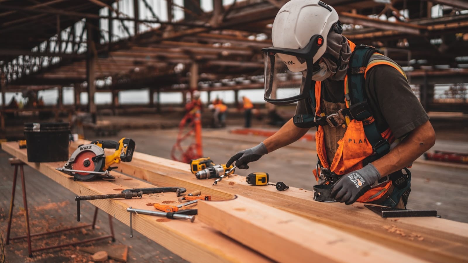 Aquicon construction worker cutting timber on an active jobsite